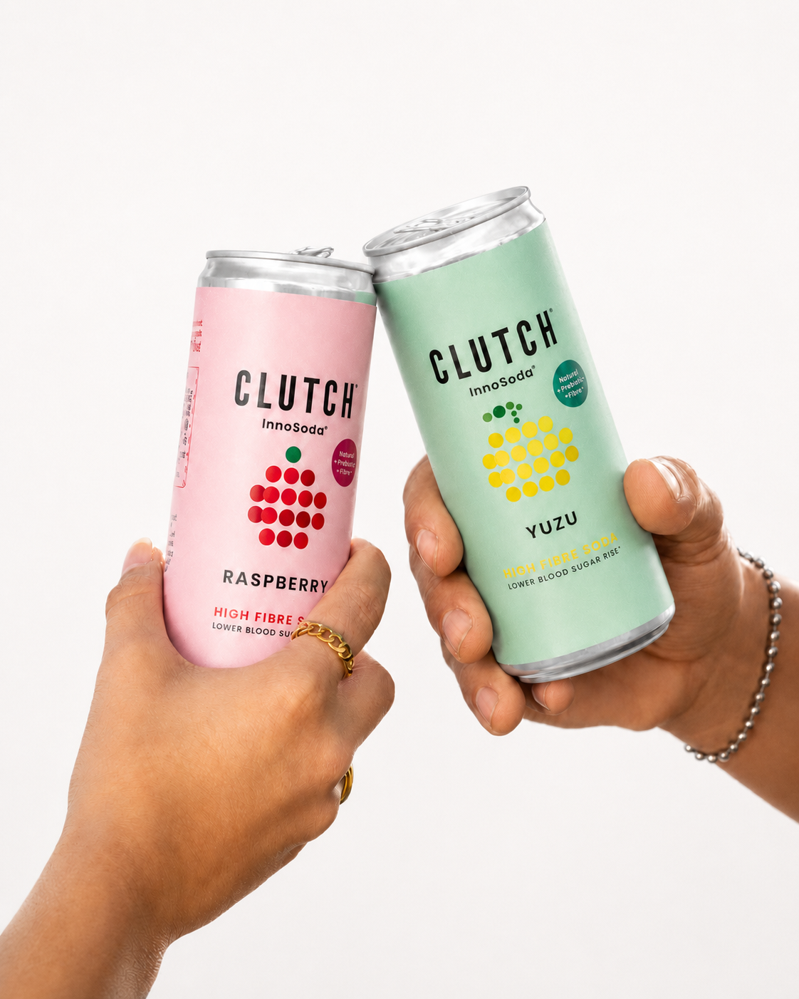 CLUTCH InnoSoda Yuzu and Raspberry high-fibre soda cans held in hand